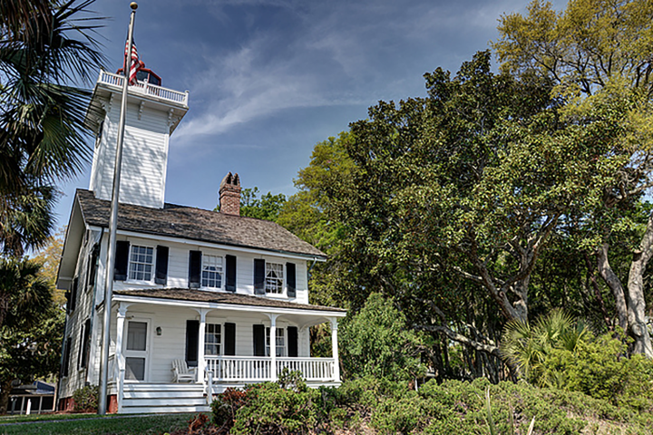 a small clock tower in front of a house