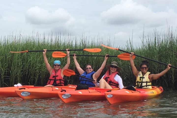 a group of people in a small boat in a body of water