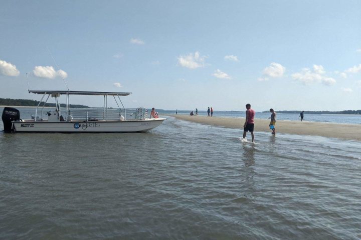 a group of people standing next to a body of water