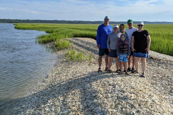 a group of people on a beach near a body of water