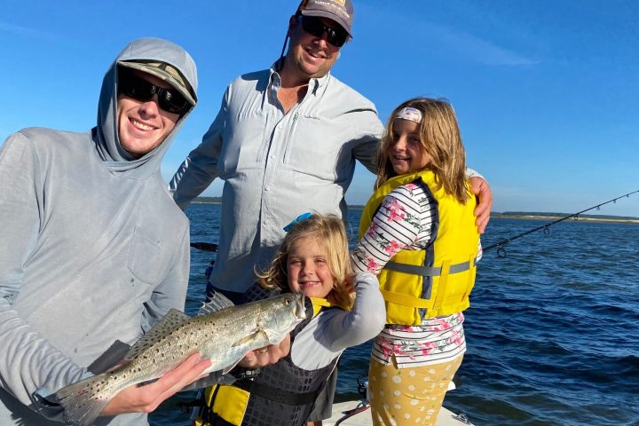 a person holding a fish in the water